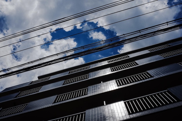 Low angle view of skyscraper against blue sky