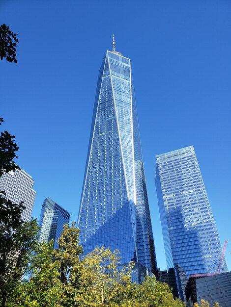 Low angle view of skyscraper against blue sky