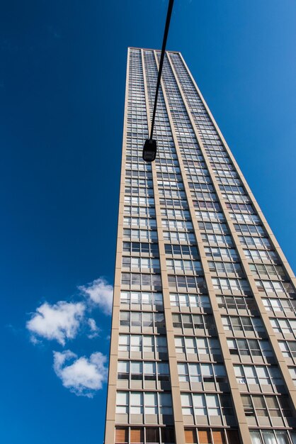 Low angle view of skyscraper against clear blue sky