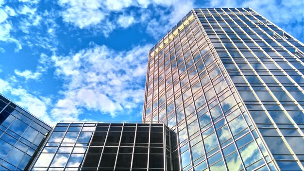 Low angle view of skyscrapers against cloudy sky