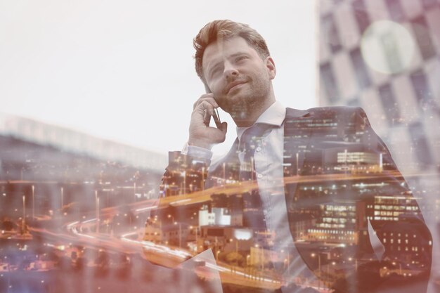 Low angle view of smart businessman talking on mobile phone