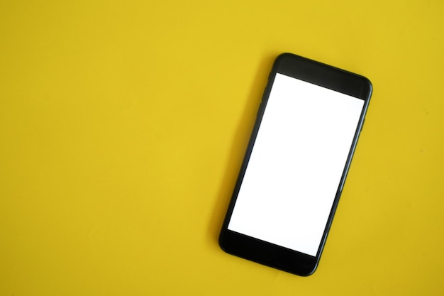 Photo low angle view of smart phone against yellow wall