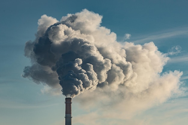 Low angle view of smoke emitting from chimney against sky