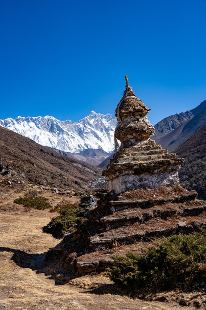 Low angle view of snowcapped mountain against clear blue sky