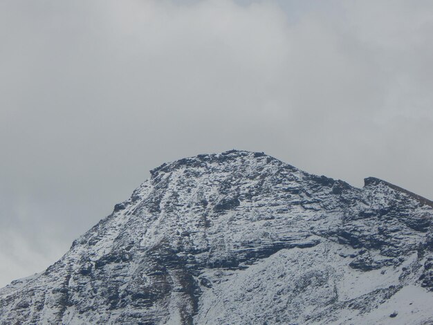 Low angle view of snowcapped mountain against sky