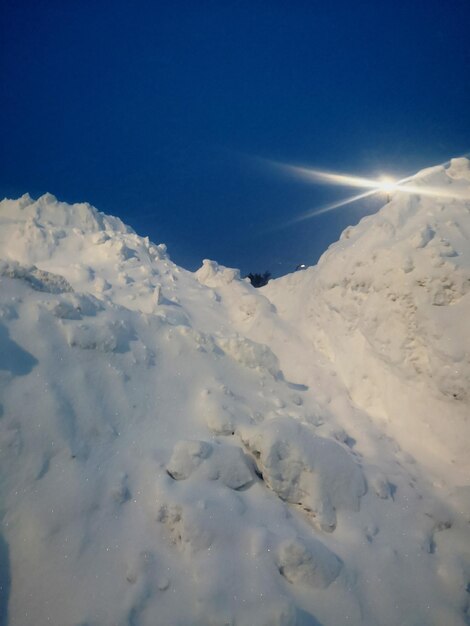 Low angle view of snowcapped mountain against sky