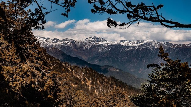 Low angle view of snowcapped mountains against sky during winter