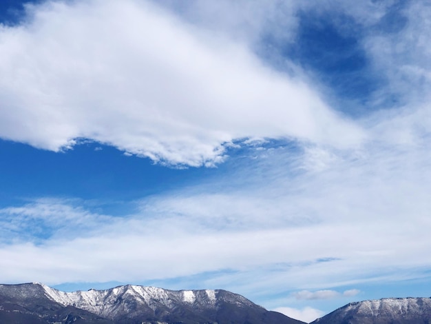 Low angle view of snowcapped mountains against sky