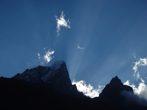 Low angle view of snowcapped mountains against sky