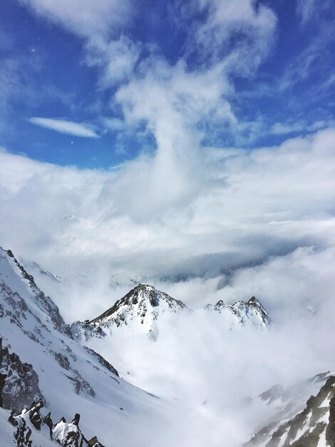 Low angle view of snowcapped mountains against sky