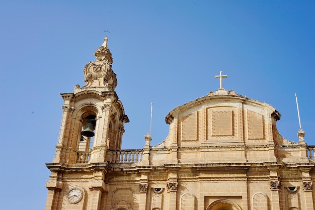 Low angle view of st joseph church against clear blue sky