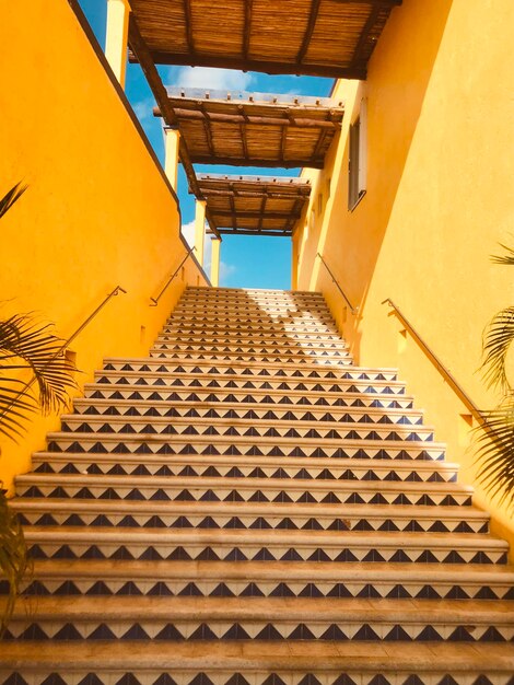 Low angle view of staircase amidst buildings