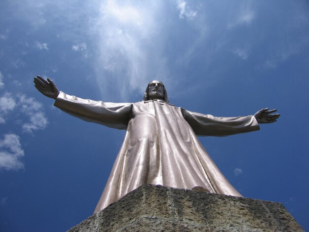 Low angle view of statue against blue sky