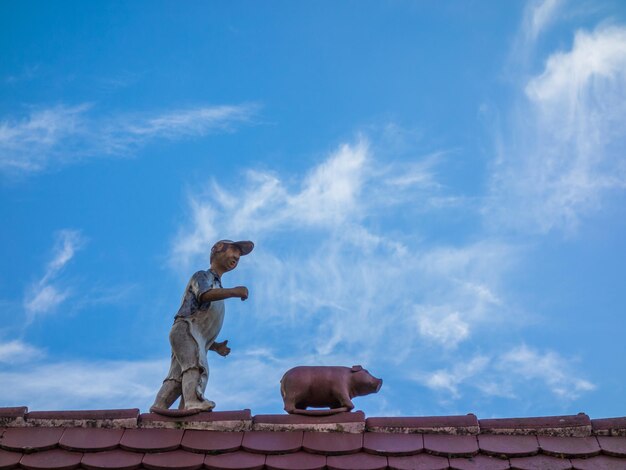 Low angle view of statue against blue sky