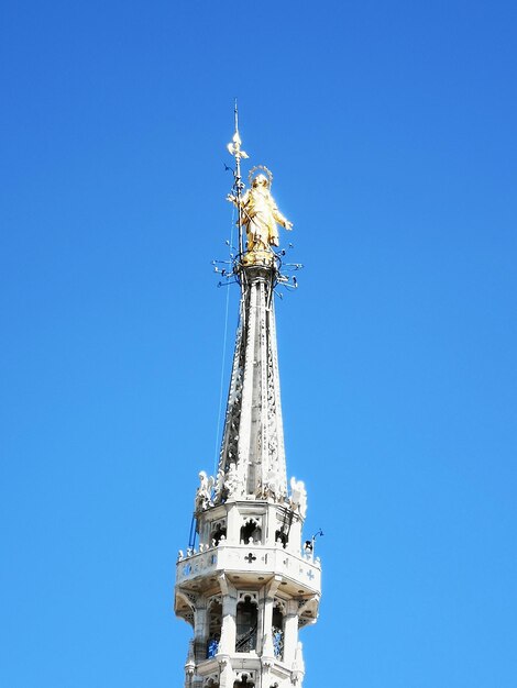 Low angle view of statue against blue sky