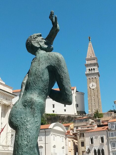 Low angle view of statue against blue sky