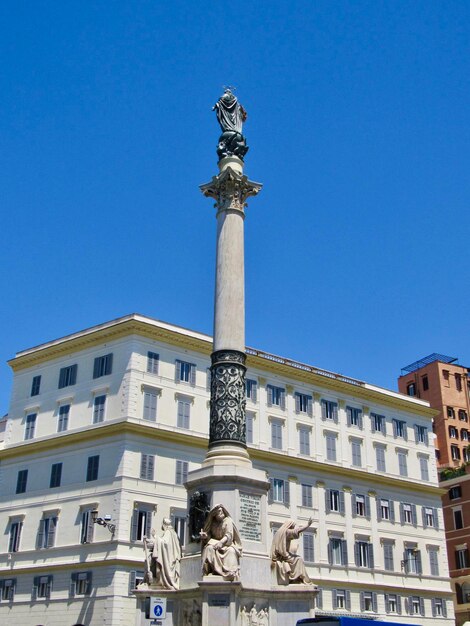 Low angle view of statue against blue sky