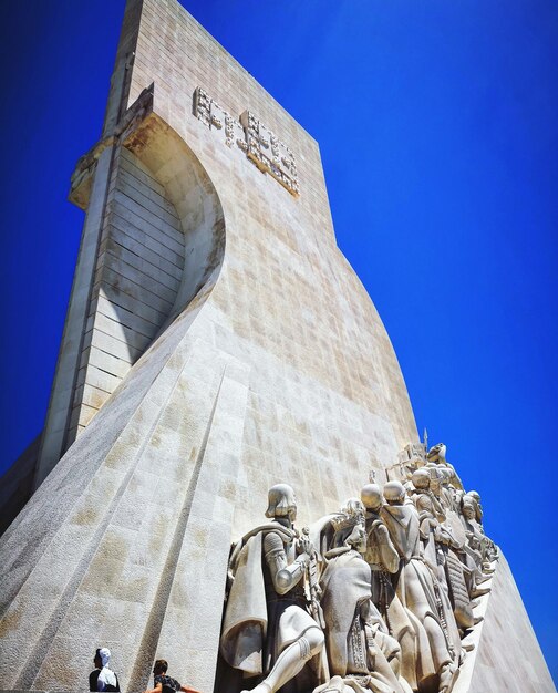 Low angle view of statue against blue sky