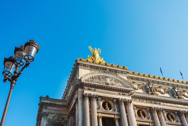 Low angle view of statue against blue sky