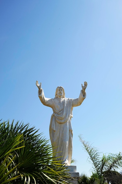 Low angle view of statue against blue sky