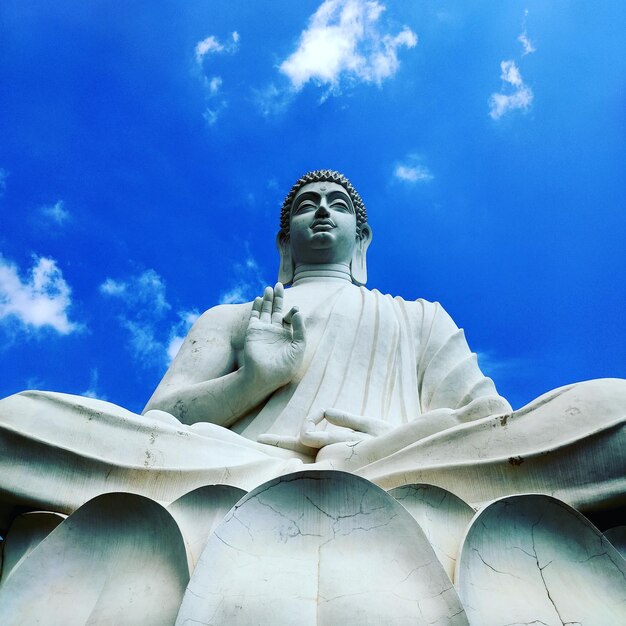 Low angle view of statue against blue sky