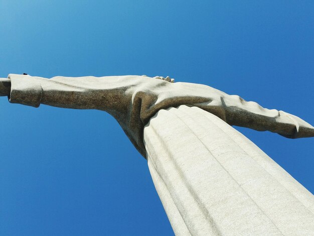 Low angle view of statue against blue sky