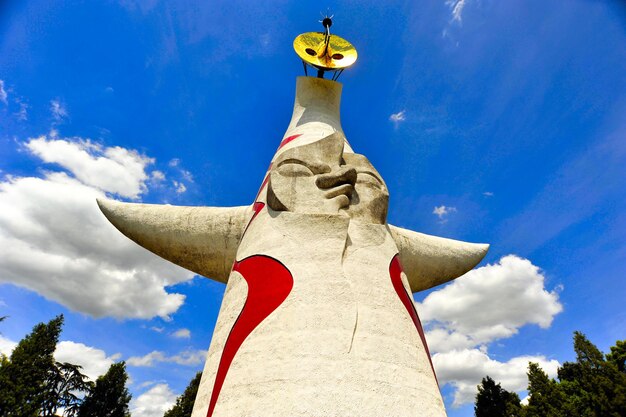 Low angle view of statue against blue sky