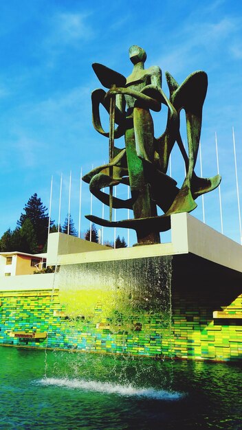 Low angle view of statue against blue sky