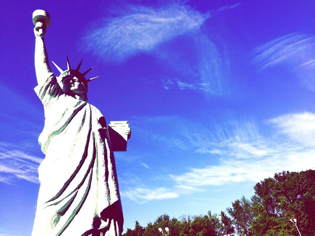 Low angle view of statue against blue sky