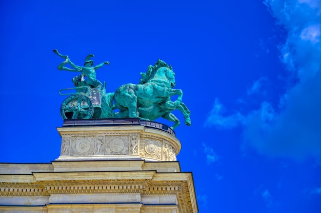 Low angle view of statue against blue sky