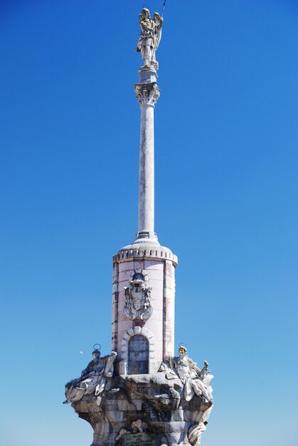 Low angle view of statue against blue sky