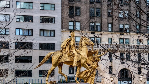 Low angle view of statue against building in city