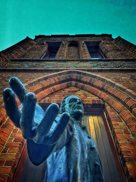 Low angle view of statue against building