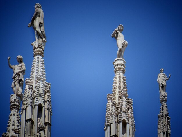 Low angle view of statue against clear blue sky