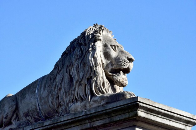 Low angle view of statue against clear blue sky