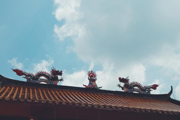 Low angle view of statue against cloudy sky