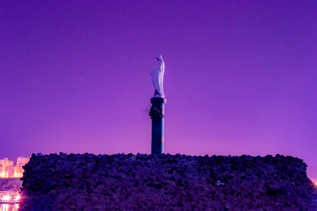 Low angle view of statue against sky at dusk