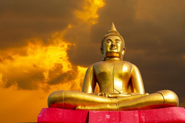 Low angle view of statue against temple against sky during sunset