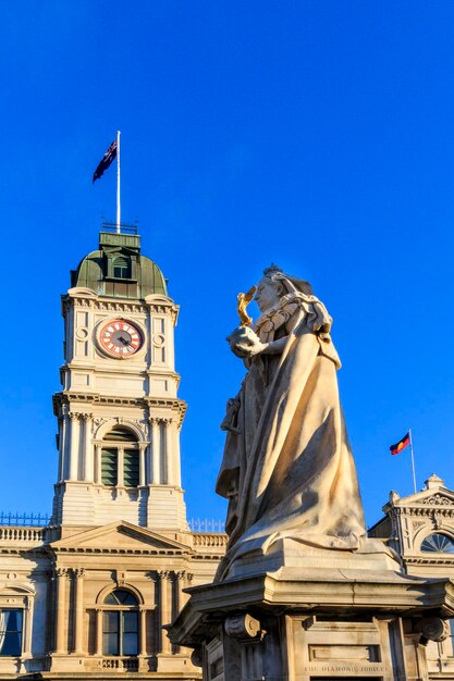 Low angle view of statue of building against blue sky