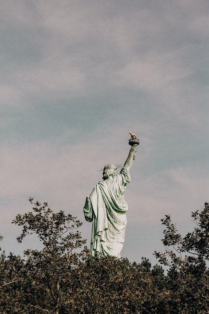 Low angle view of statue of liberty against sky