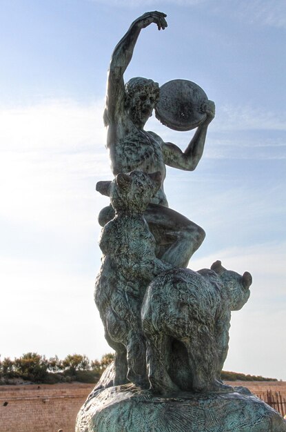 Low angle view of statues against sky