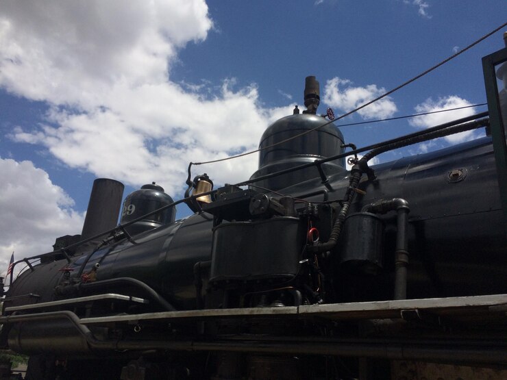 फोटो low angle view of steam train against cloudy sky