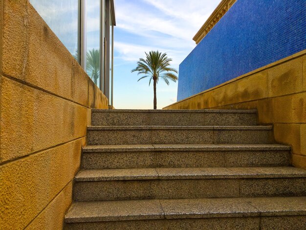 Low angle view of steps by building against sky