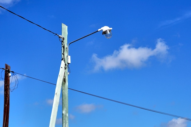 Low angle view of street light against blue sky