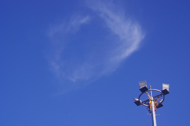 Low angle view of street light against blue sky