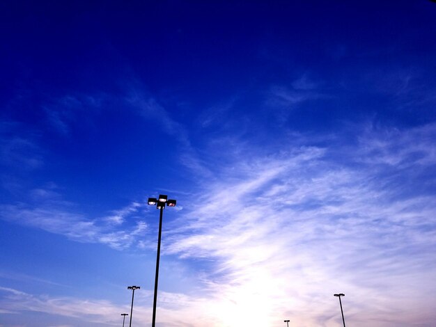 Low angle view of street light against blue sky