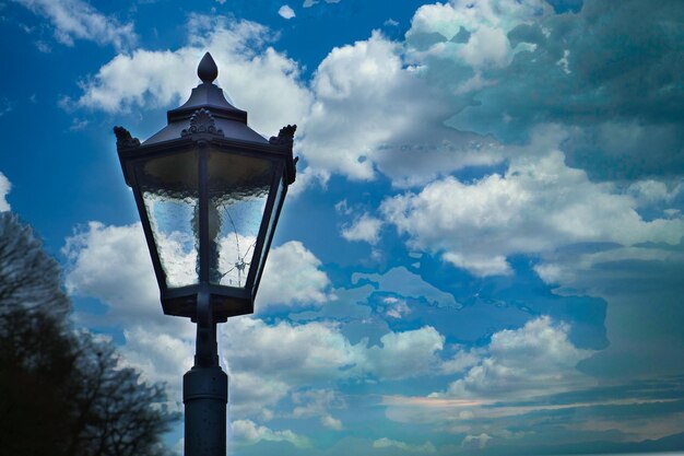 Low angle view of street light against blue sky