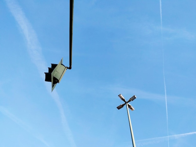 Low angle view of street light against blue sky