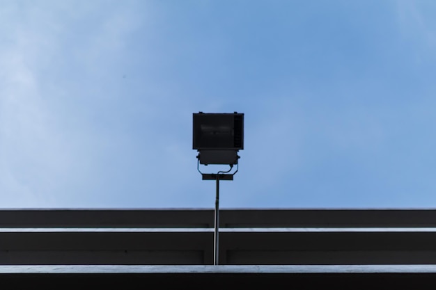 Low angle view of street light against building against sky