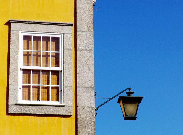 Low angle view of street light against building